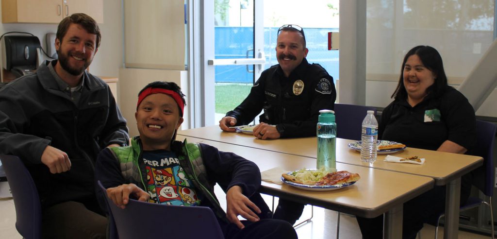 Main DSS class image An event image of disability support services students with their instructor and a city of cypress police officer.