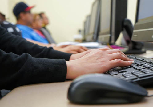A photo of a student's hands on a keyboard.