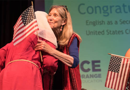 Two students receiving their citizenship certificates