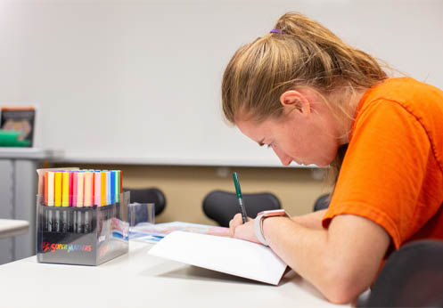 ARISE lab student coloring a picture