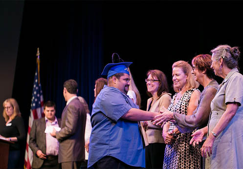 DSS student recieving their certificate at the NOCE Student Success and Scholarship event