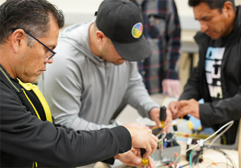 Two electrical students working on a project together