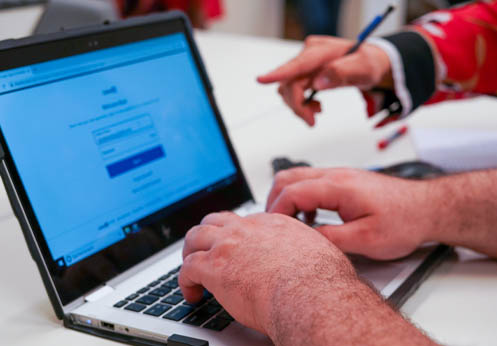 Photo of an NOCE student using a laptop in the Career Resource Center