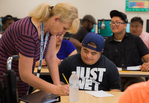 A DSS teacher working with a student on an assignment