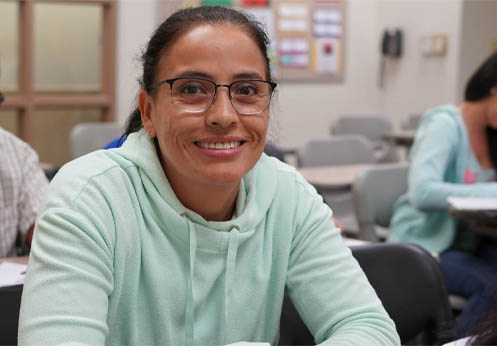 A smiling parenting student in class.