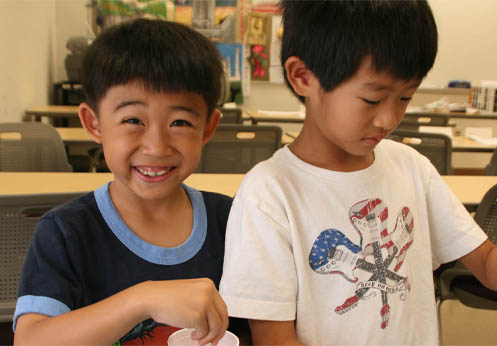 Two little boys working on an arts and crafts project