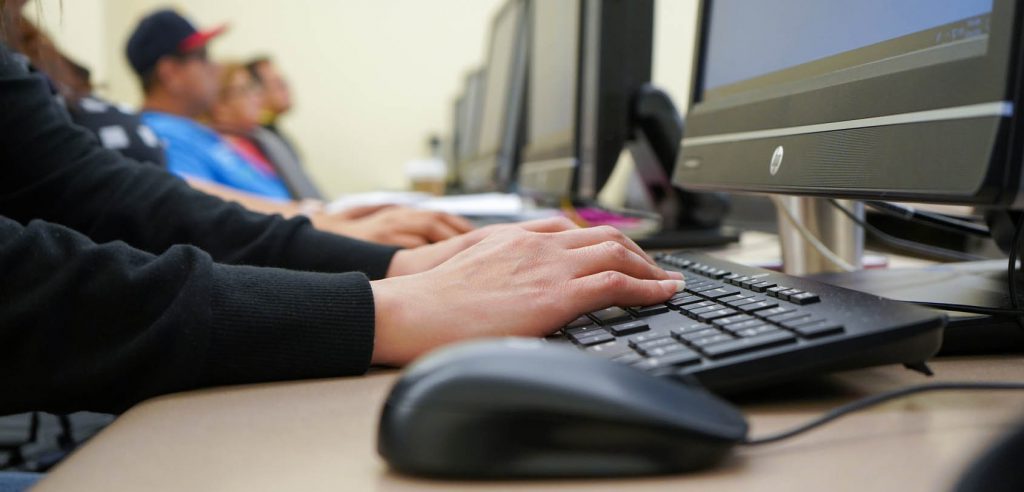 A photo of a student's hands on a keyboard.