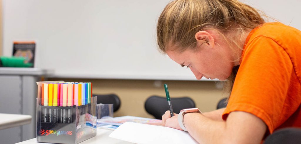 ARISE lab student coloring a picture