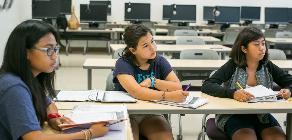 A photo of three teen math students.