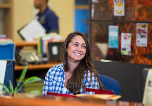 An Admissions and Records assistant at the front desk.