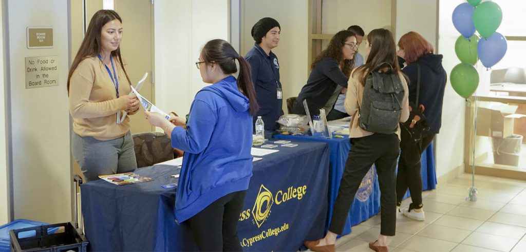 A photo of Fullerton College and Cypress College hosting a resource table at NOCE. 