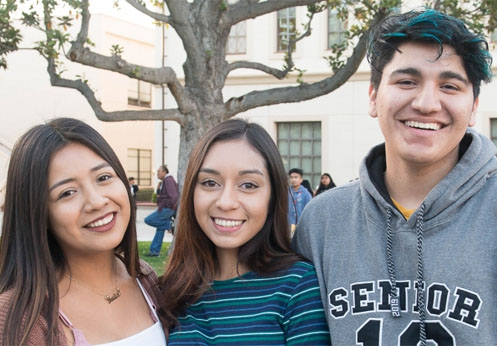A photo of three smiling Fullerton College Students.