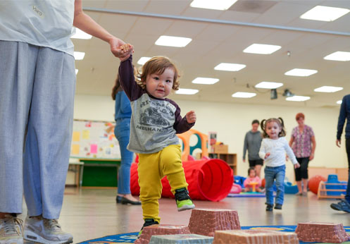 A baby learning to walk.