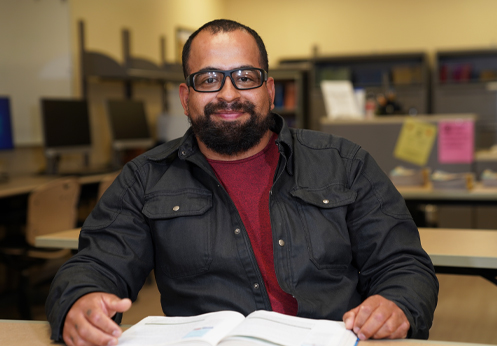 A smiling high school diploma attending the Anaheim campus high school lab