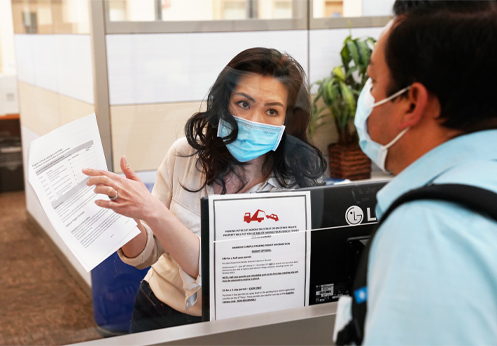 An admissions and records technician going over school information with a student