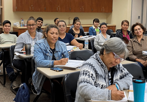 A large ESL class posing for a picture.