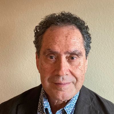 Enrique Moreno, wearing dark blazer and blue patterned shirt in professional headshot